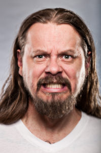 Caucasian Man With Long Hair Looking Angry