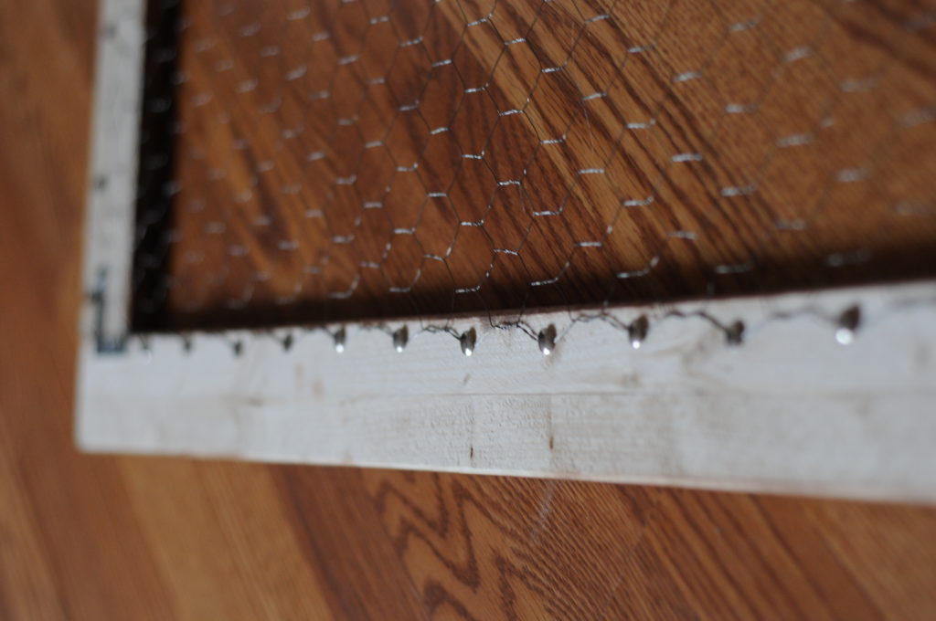 DIY- Create this holiday card holder for under $15. Using chicken wire and stained wood.