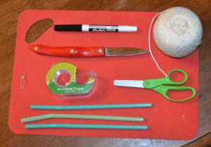 scissors, knife, straws, cutting board, dry erase marker, string, tape