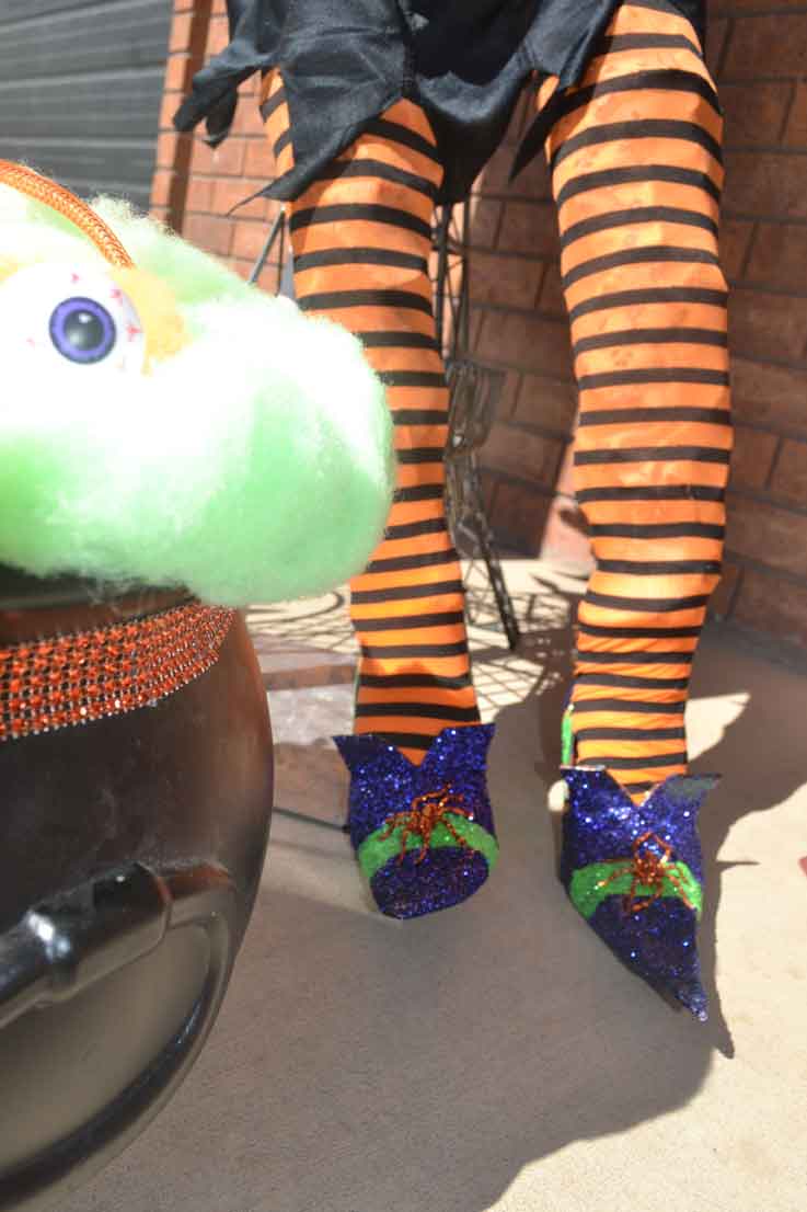 life size Halloween witch shoes, tights, cauldron decorations
