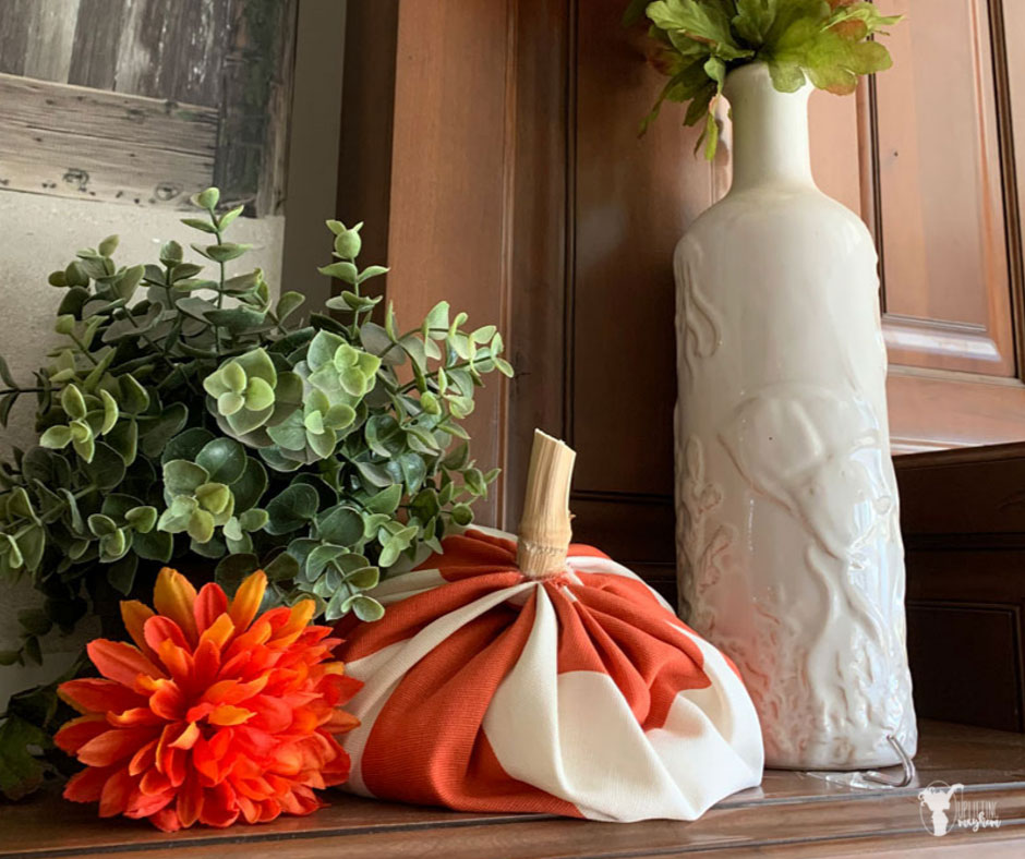 This fabric pumpkin decoration is incredibly easy to make and looks great added to your home decor or as a center piece for your next Halloween Party! Perfect Halloween or Fall decoration and centerpiece.