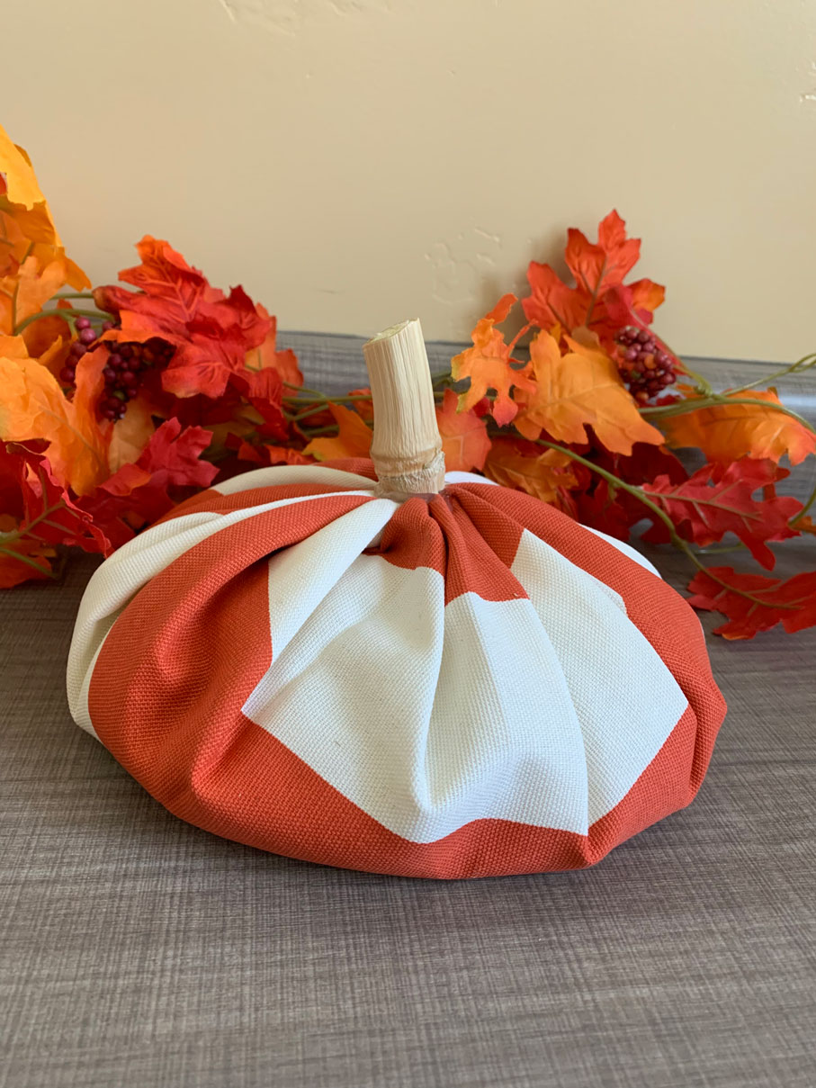 This fabric pumpkin decoration is incredibly easy to make and looks great added to your home decor or as a center piece for your next Halloween Party! Perfect Halloween or Fall decoration and centerpiece.